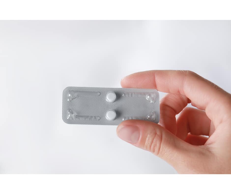 Hand holding emergency contraception pill pack – birth control method used to prevent pregnancy after unprotected sex or contraceptive failure